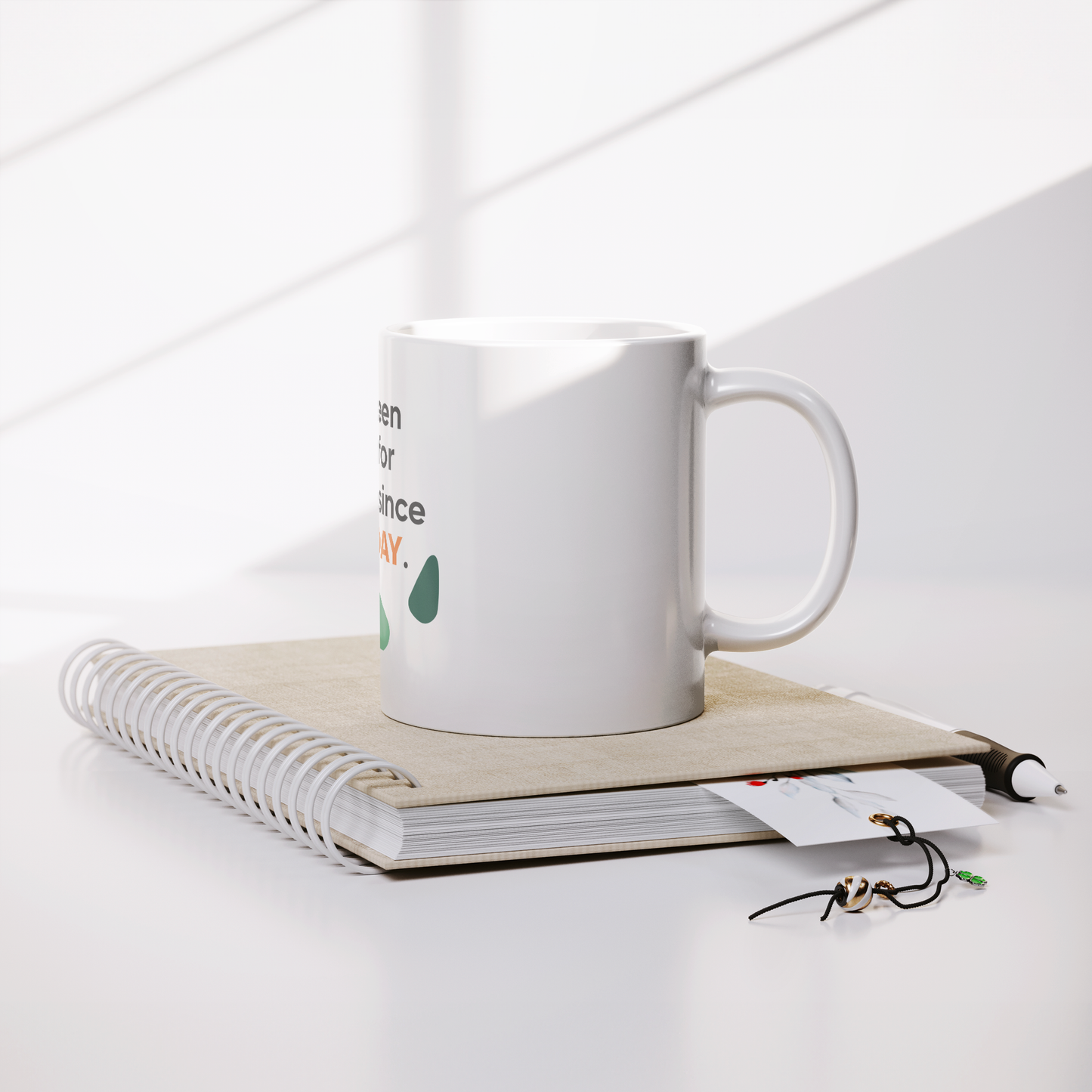 11oz_White_Mug_From_CustomCat_Lifestyle_Notebook_Mockup.png