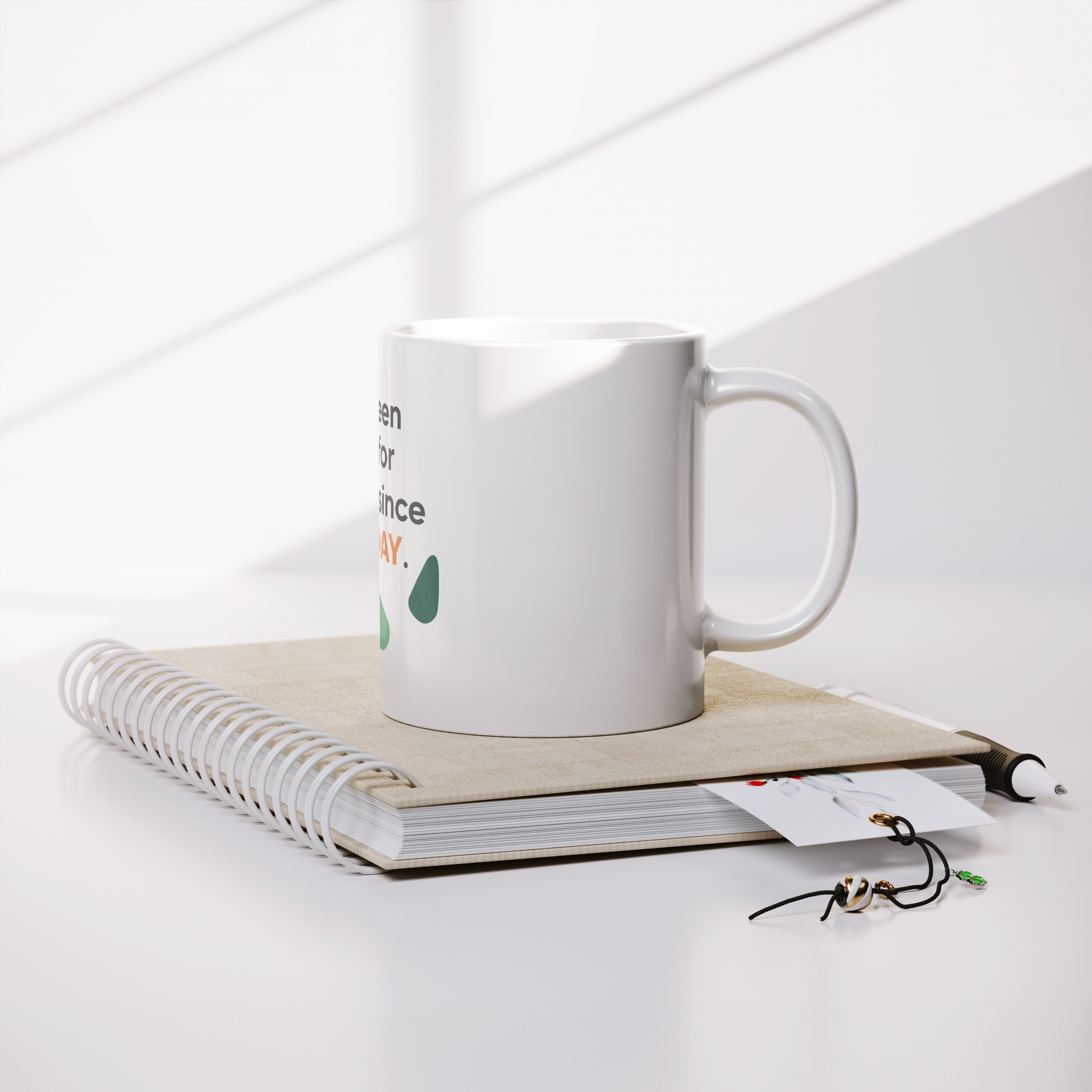 11oz_White_Mug_From_CustomCat_Lifestyle_Notebook_Mockup.png